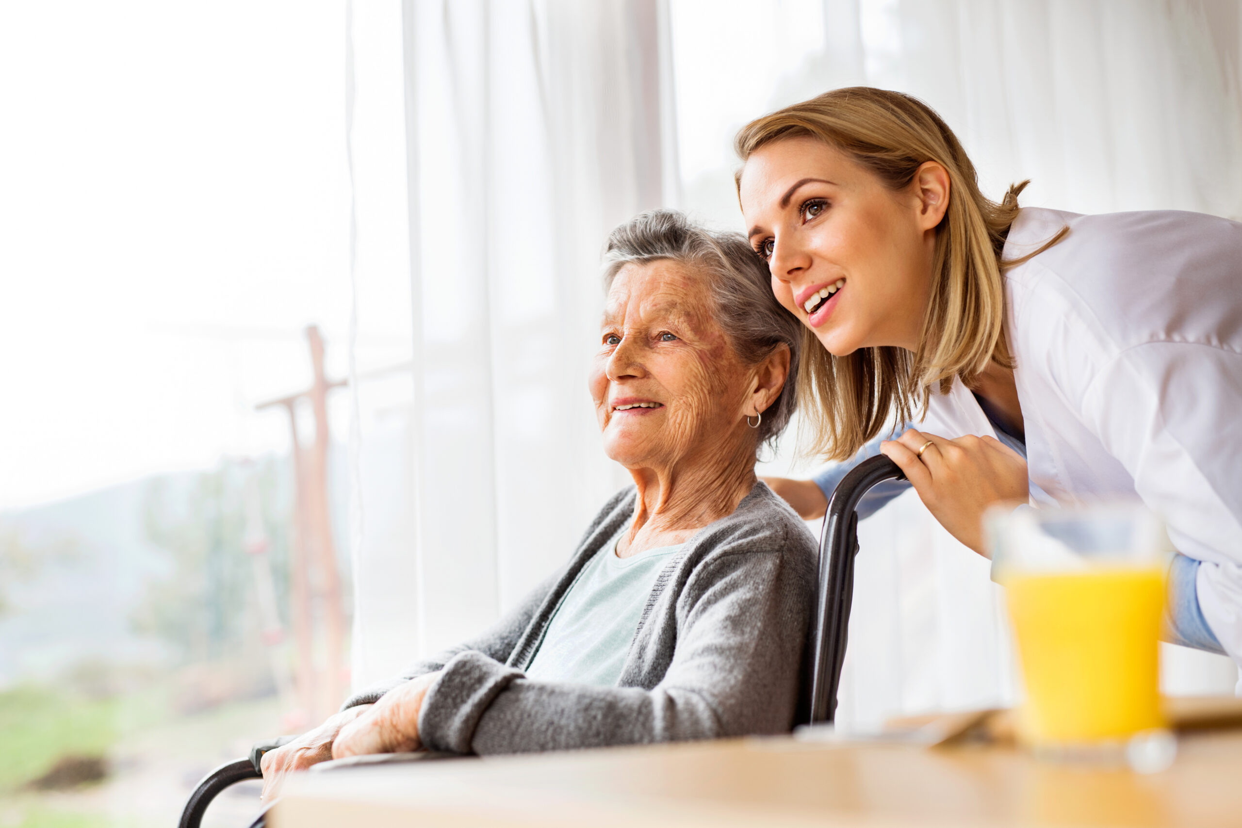 Family caregiver taking a restful break while a professional helps