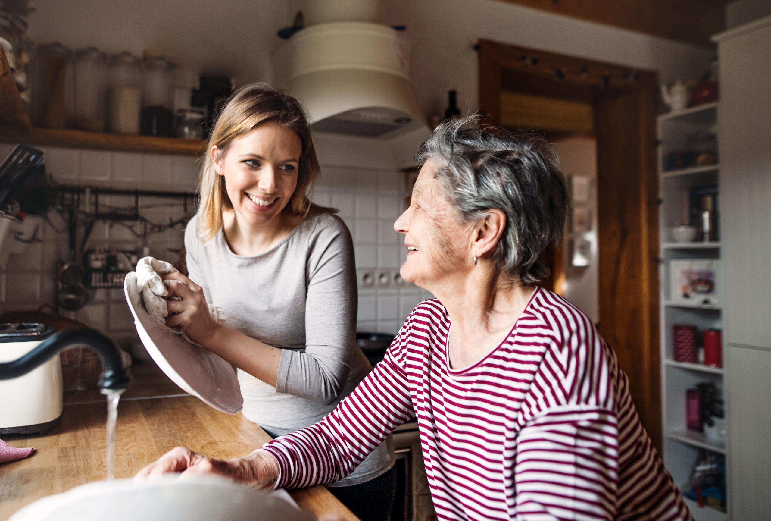 Caregiver neatly folding fresh laundry in a clean home