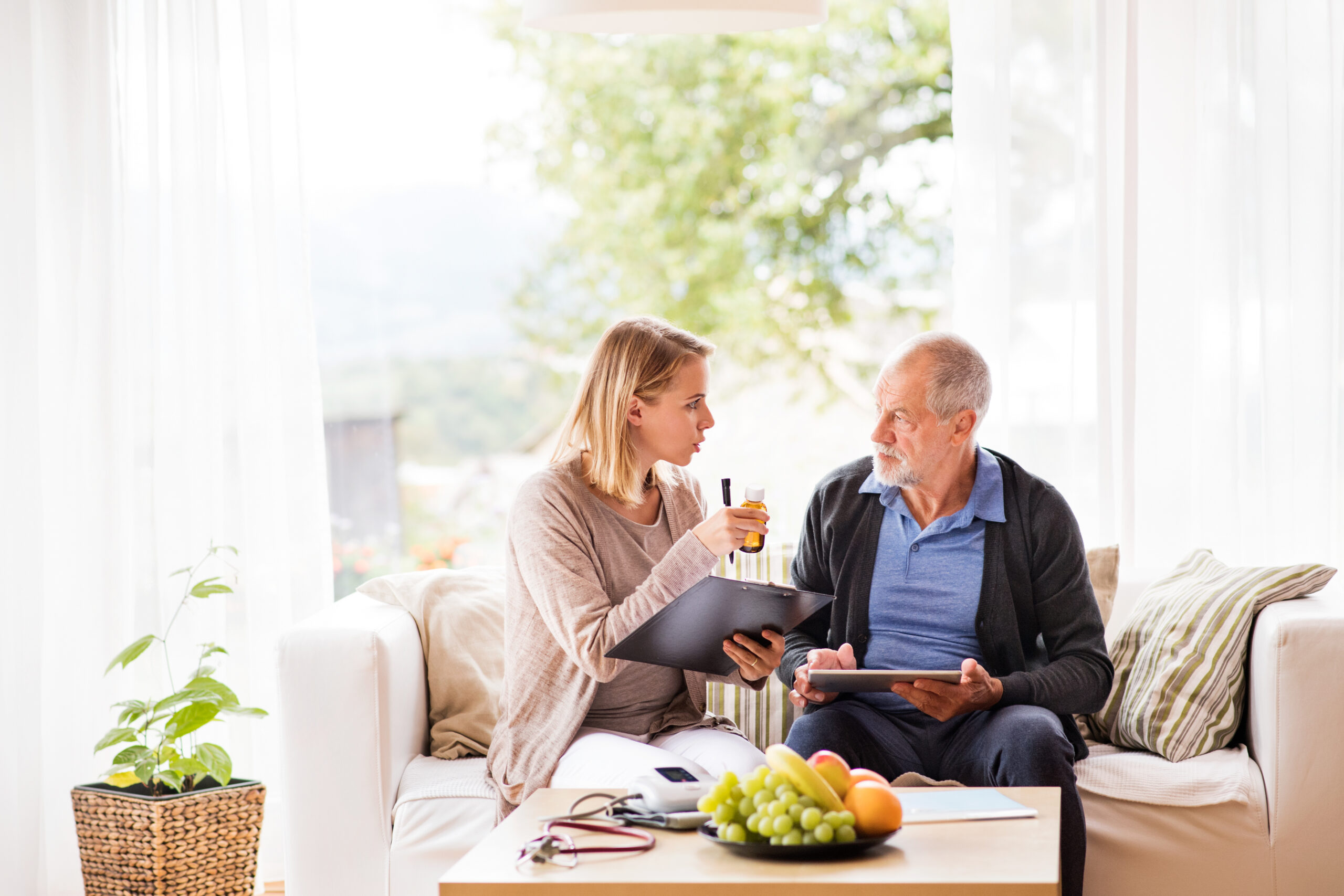 Caregiver helping a senior manage their medication schedule
