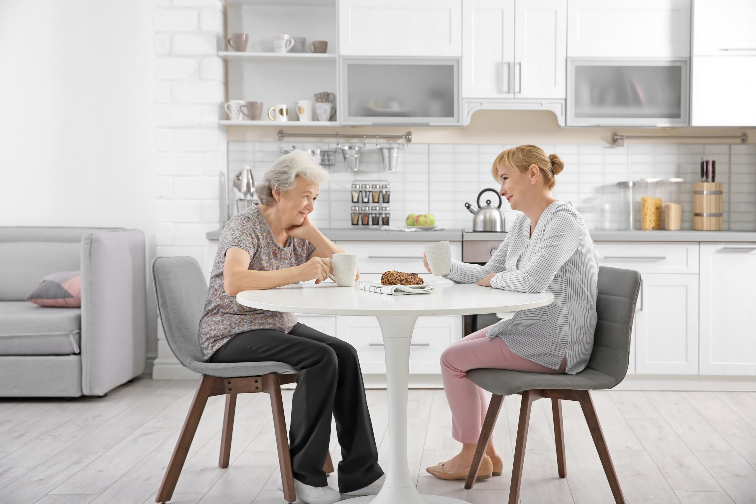 A senior and a caregiver sharing a happy moment together